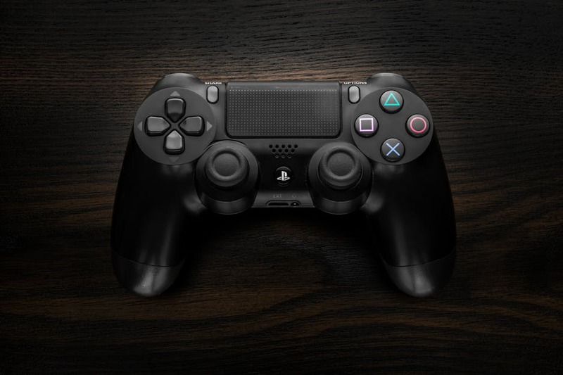 A close-up of a modern gaming controller, symbolizing the act of playing and streaming games.